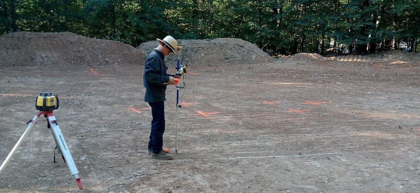 A person surveys land for construction.