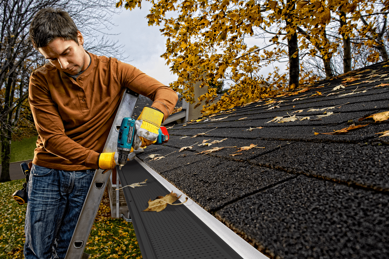 A person installs Gutter Guards.