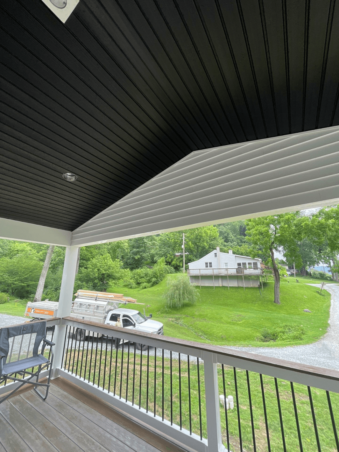 A new covered porch and deck with black interior roof.