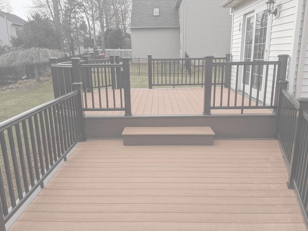 A brown deck with black railings.