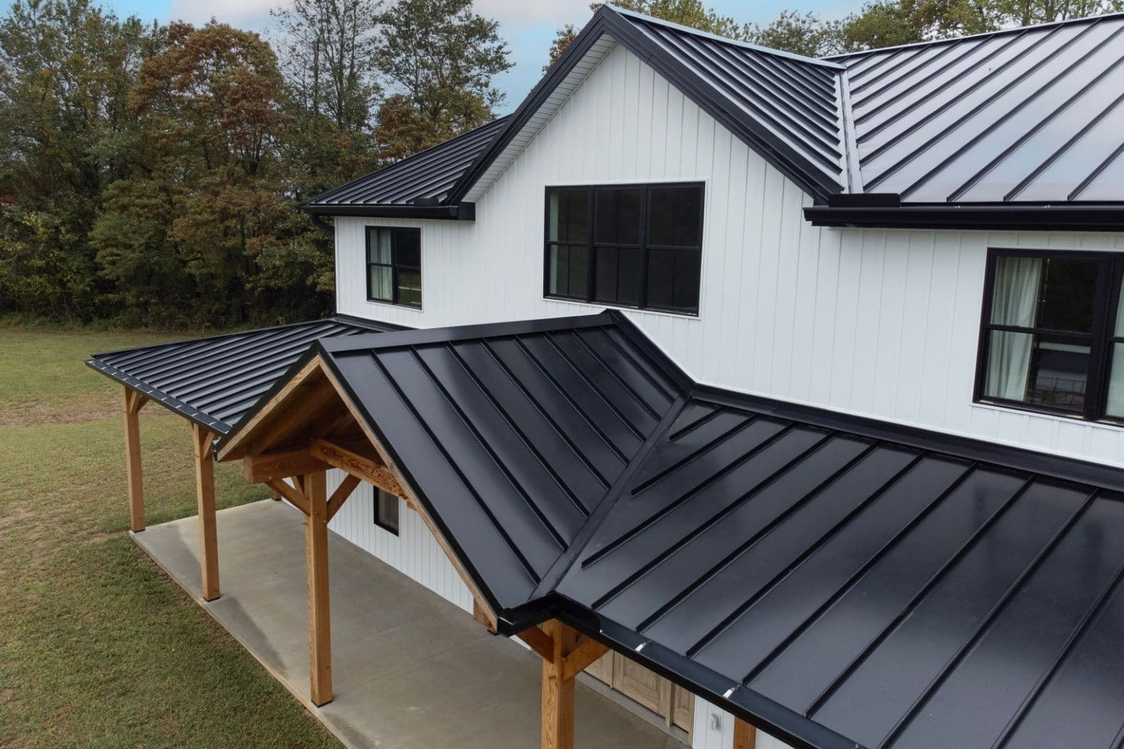 Black metal roofing on a white building.