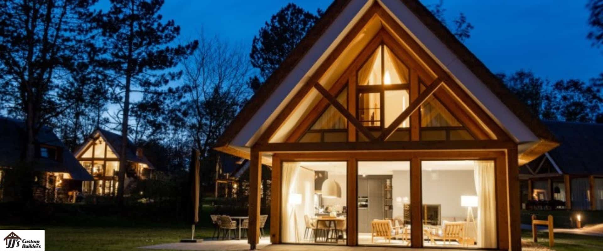 A barndominium lit up at dusk.