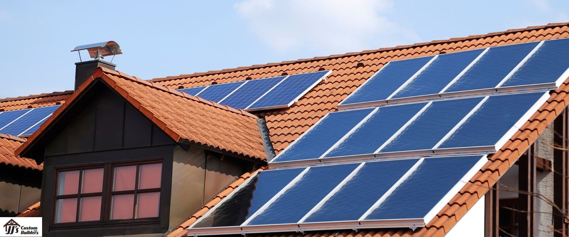 A tile roof with solar panels on it.