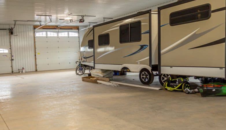 An RV parked in a barndominium.